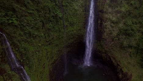 drone footage of akaka falls in hawaii - 2 water falls - pan up and further pull away