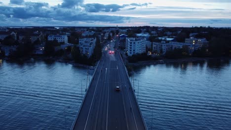 People-cross-Helsinki-bridge-during-evening-blue-hour,-Nordic-dusk