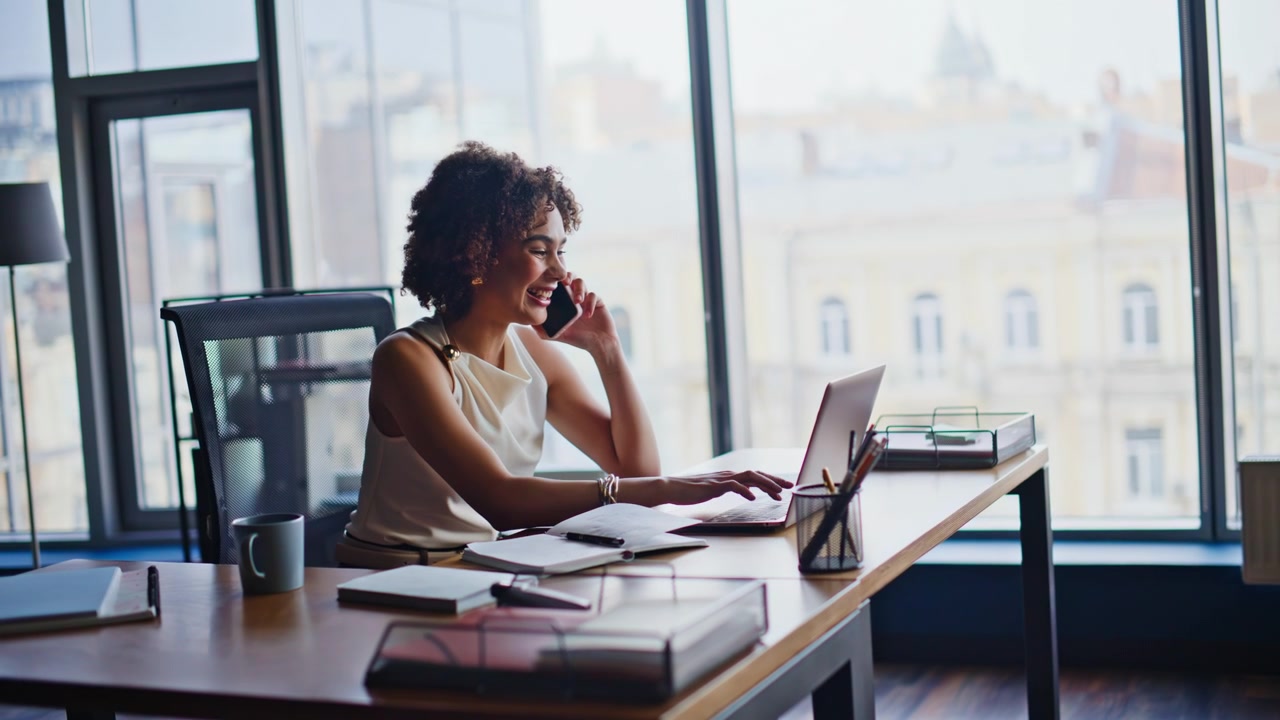 Businesswoman calling phone taking notes office. Entrepreneur working laptop