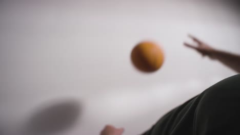 studio shot of male basketball player dribbling and passing ball to team mate