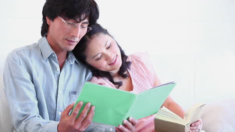 man reading a booklet with a woman