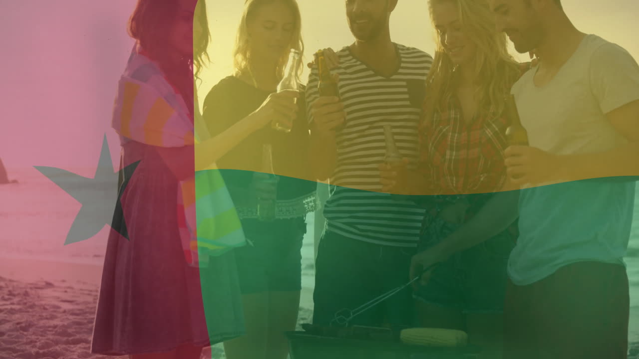 At beach, friends having barbecue with Ghana flag animation overlaying scene