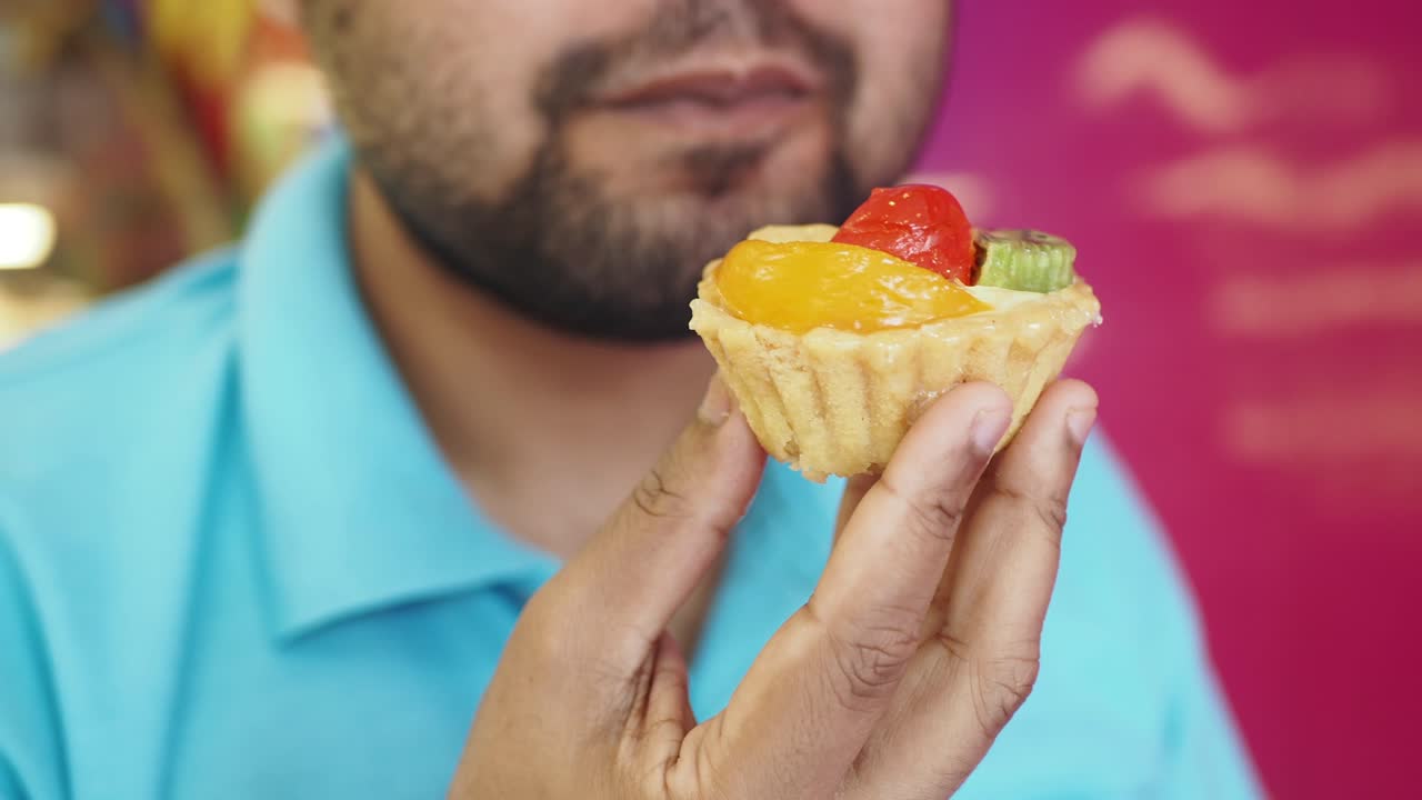 Man Eating a Fruit Tart
