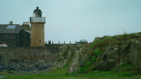 lighthouse in the small village harbour of portpatrick