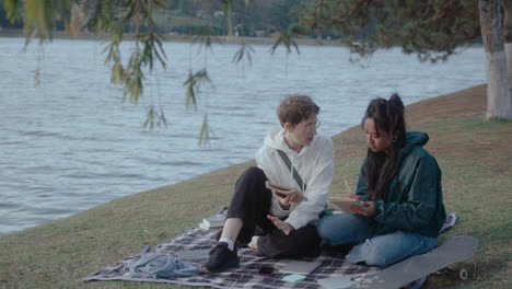 girls discussing college homework in the park