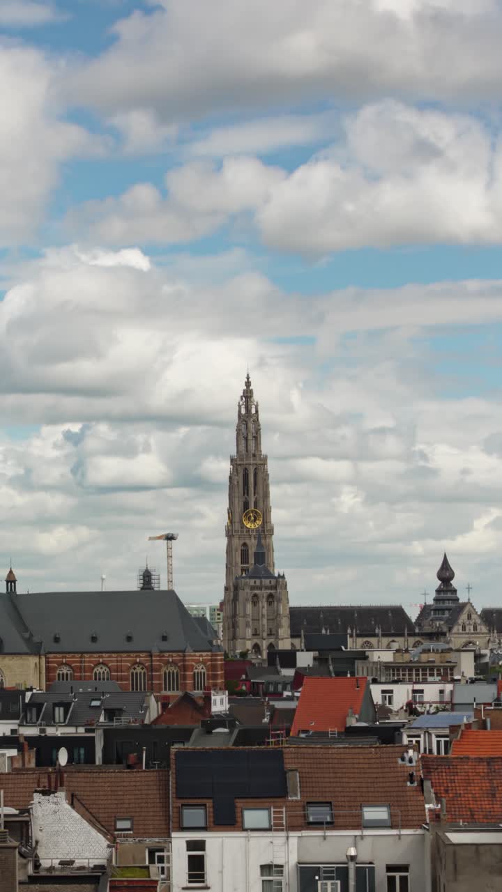 Vertical timelapse of Cathedral of Our Lady above the Antwerp skyline with moving clouds