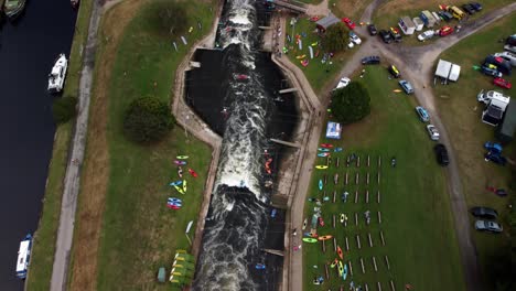 drone video of the holme pierrepont white water course and moving along the course while panning up to so the end of the course and the surroundings including the rowing course.