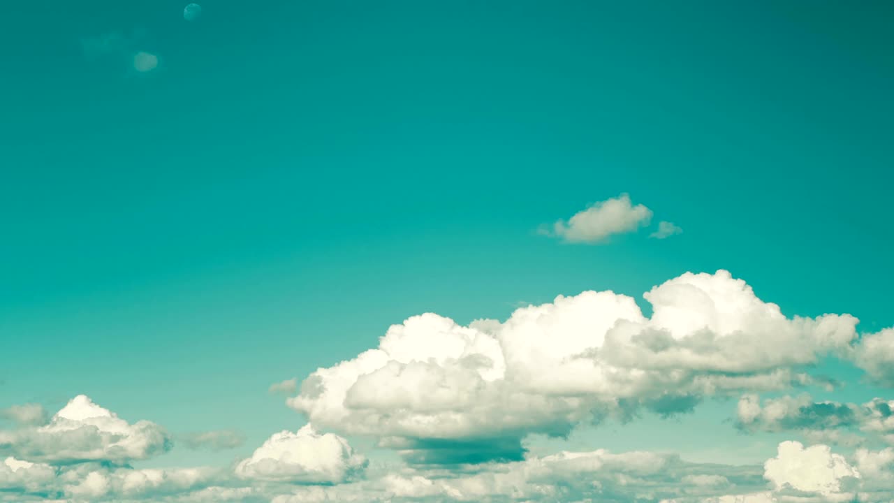 Creation of clouds on the background of the azure sky. The motion of large clouds on a blue sky. Retro colors. time lapse