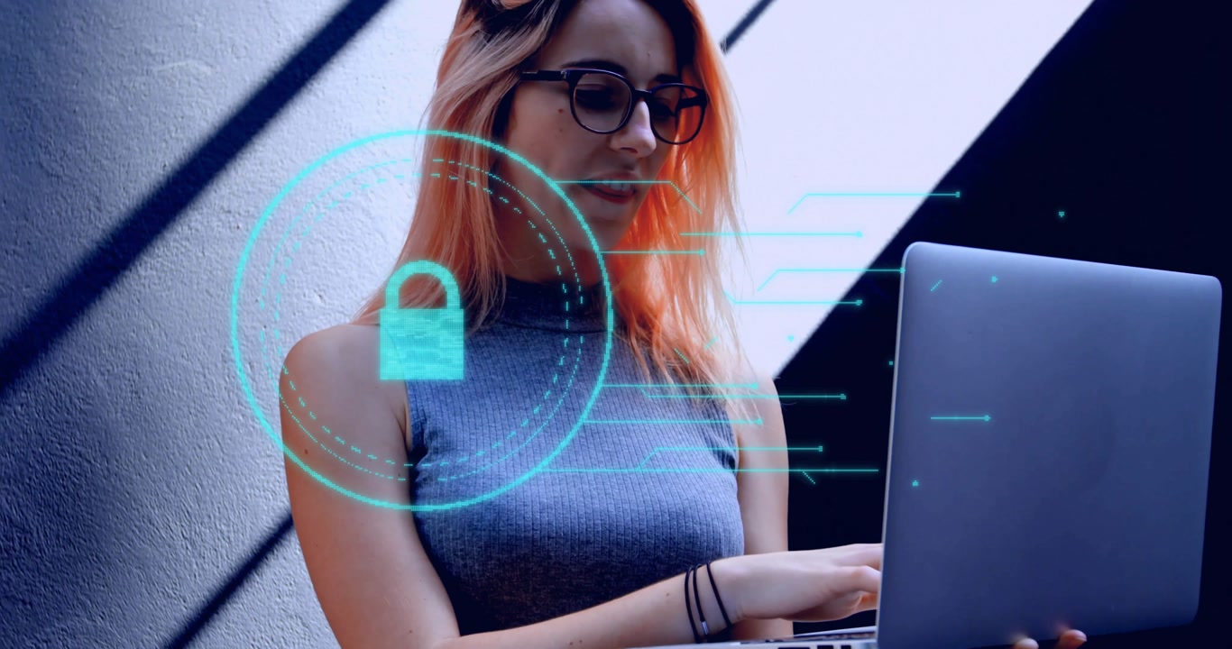 Female developer wearing glasses typing on laptop in tech lab, showcasing glitchy overlay