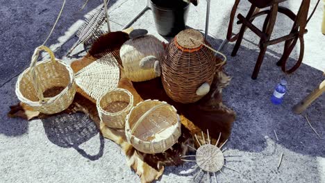 Golden-and-dark-brown-woven-baskets-from-wooden-reeds-sti-on-ground-of-lonoa-spain-at-festival