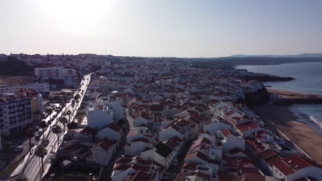 aerial pullback from ericeira downtown revealing scenic atlantic coastline