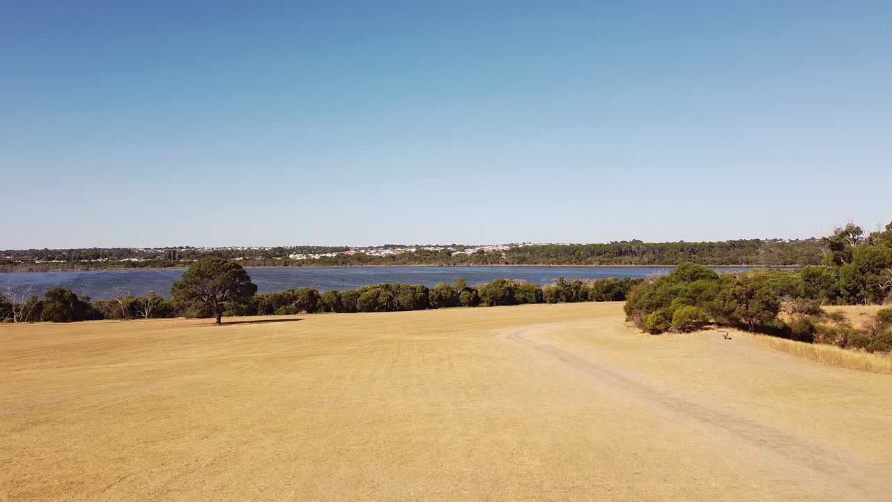 Aerial footage flying towards lake Joondalup in Perth Western Australia