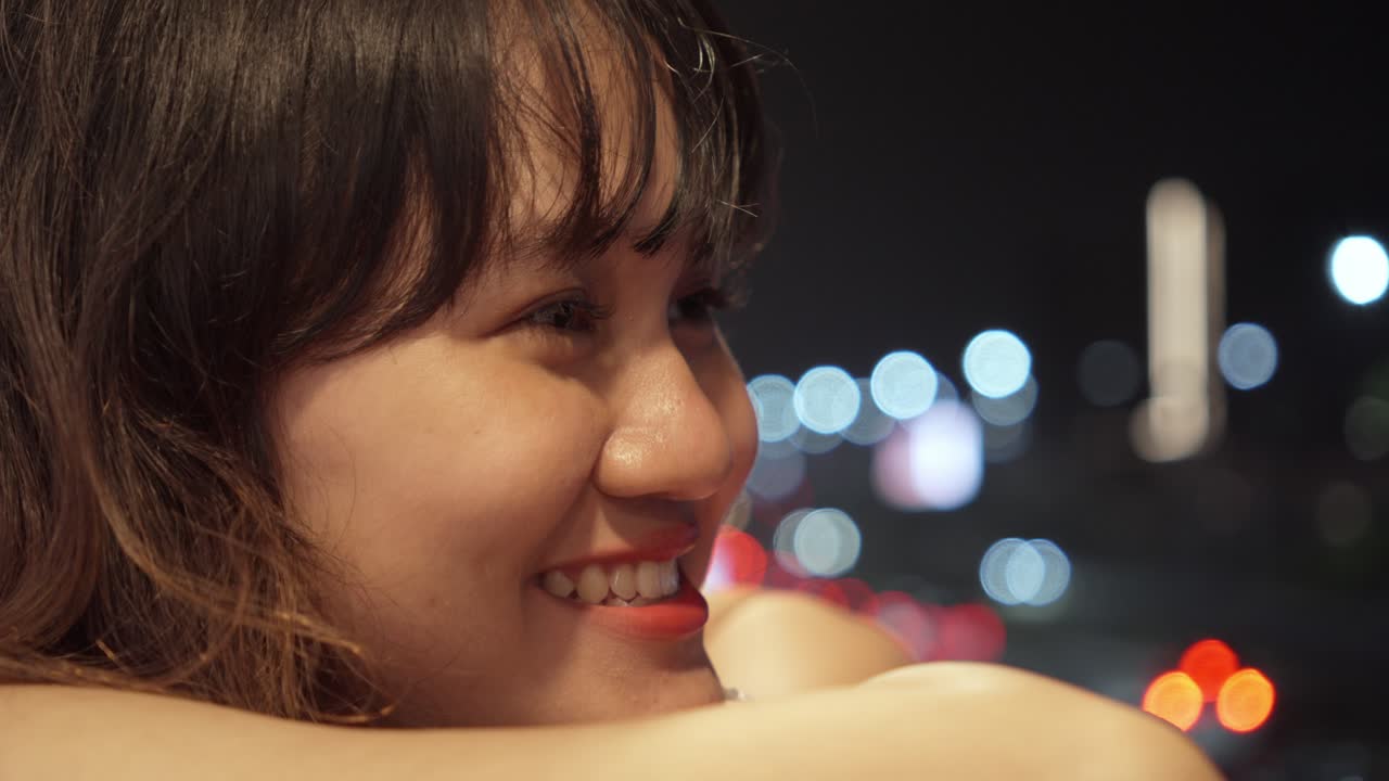 Close-up Portrait Of A Happy Woman With The City Light Backdrop.