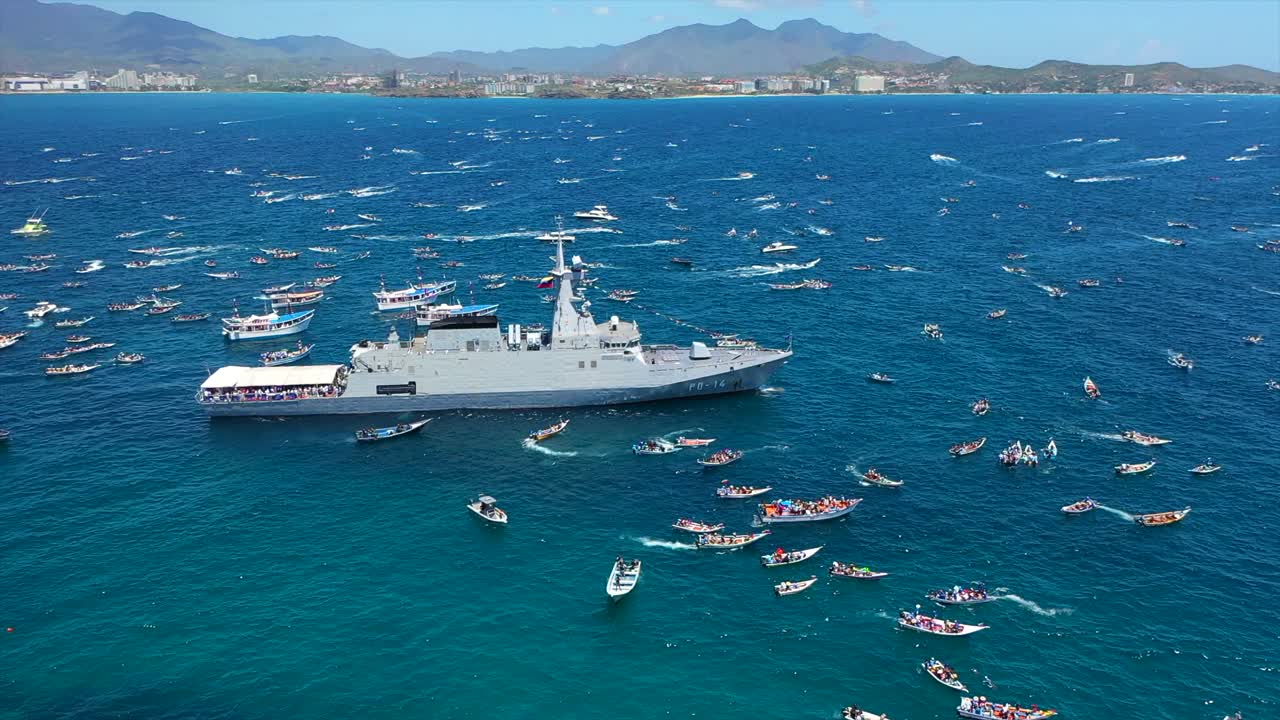 Procession at sea with boats and military ship for Virgen del Valle celebration