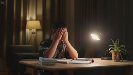 asia boy feel pain eyestrain rubbing dry irritated eyes fatigued from doing home work
