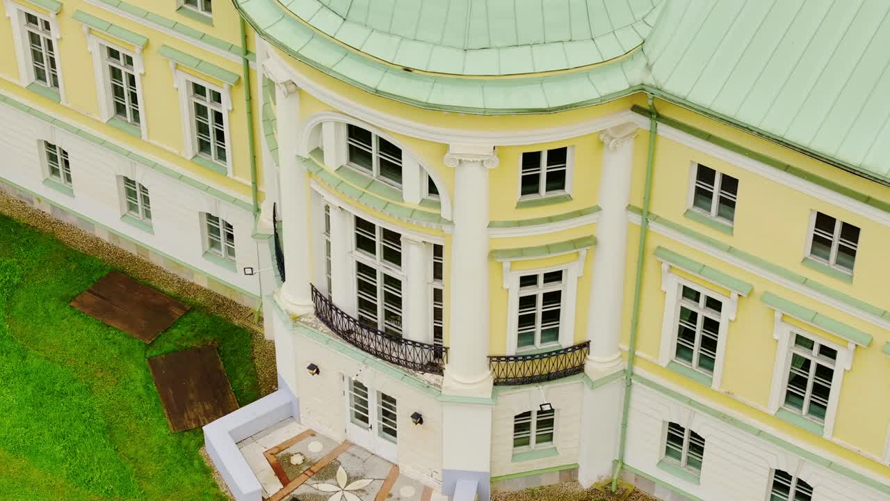 Drone flies upward while tilting down over architectural detail, Mežotne Palace