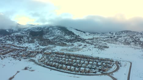 small-village-at-base-of-mountain-with-clouds-rolling-in