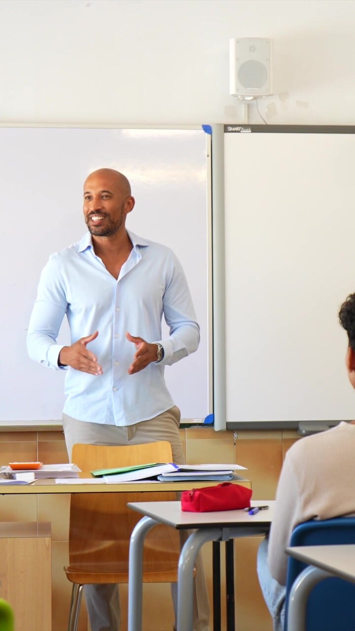 Male Teacher Giving a Lesson to Students in a Classroom