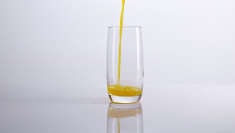 pouring orange juice into a glass