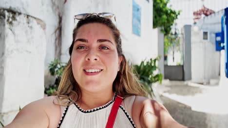 vlogger woman looking up while filming in athens