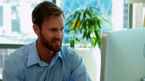 Male-executive-working-over-computer-at-his-desk