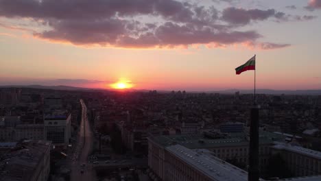 bulgarian flag waiving in the wind during a beautiful sunset in the city of sofia