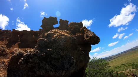 large rock formations with blue sky and white clouds.