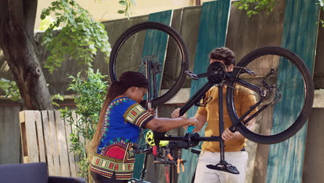 multiethnic couple securing bicycle