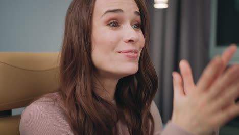 portrait of business woman laughing while watching video online at computer