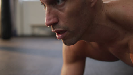 Caucasian-muscular-shirtless-bald-man-exercising-and-doing-plank