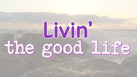 animation of the words livin' the good life written in purple and white over sunset coastal sea view