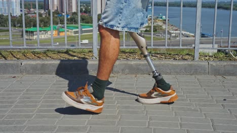 person with a prosthetic leg walking in a city