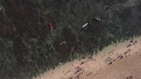 aerial view, activities of holiday tourists on sadranan beach, gunung kidul, yogyakarta using canoes and swimming