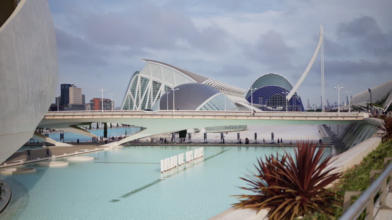 Valencia, Spain - May 28, 2025: White Palau de les Arts letters floating on the pool with the building's sweeping forms behind