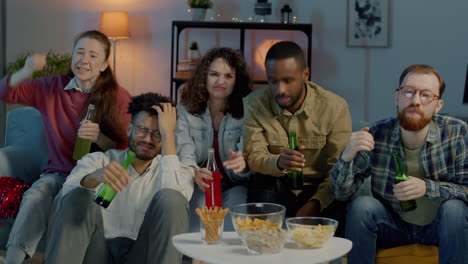 friends watching tv and celebrating
