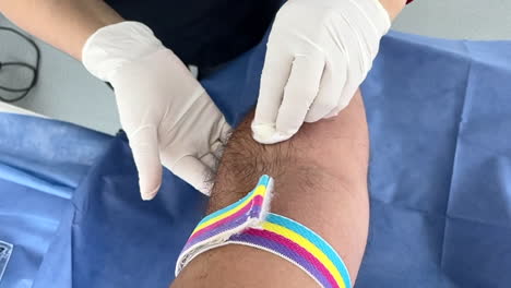 nurse cleans and prepares pacient's arm for injection