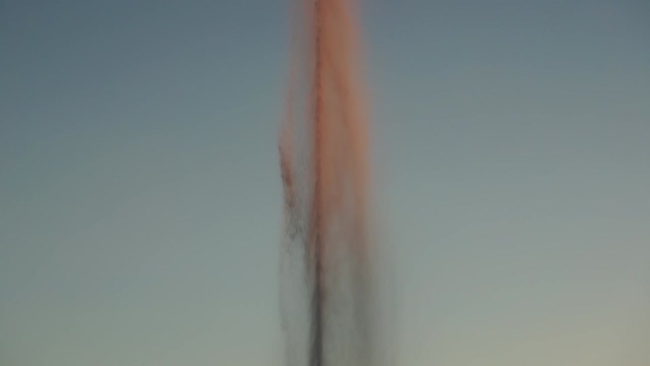 Tilt reveal shot of fountain in pond in Parque de Las Cruces, Madrid, slow motion