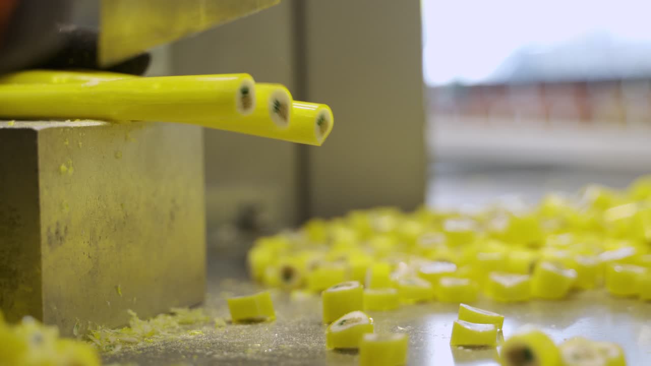 Knife chopping yellow candies in a pile