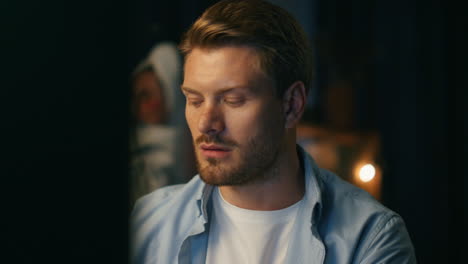 Busy-man-working-distantly-dark-flat-closeup.-Freelancer-ignoring-dancing-woman