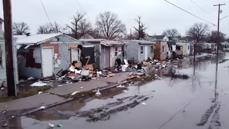 devastating aftermath of flooding: homes destroyed and streets submerged in debris and water, highlighting the urgent need for recovery and support in affected communities