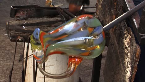 craftsman making the handle of a glass vase