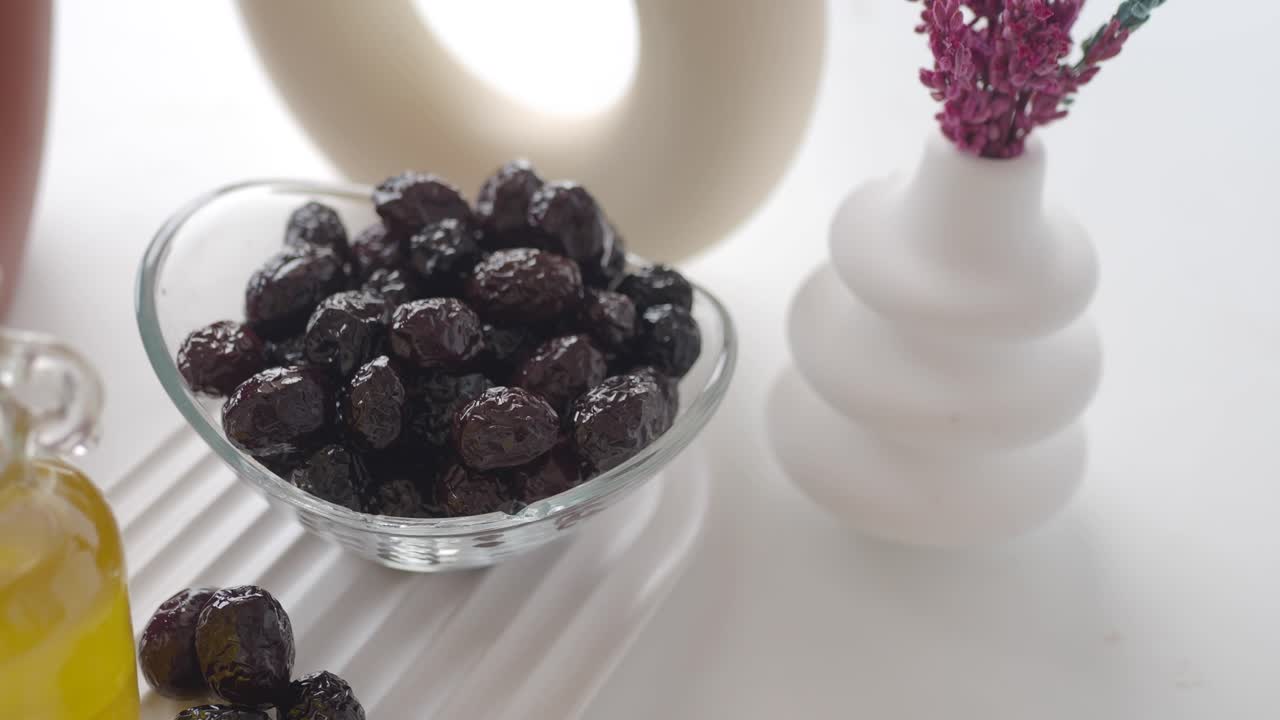 Black Olives in Glass Bowl with Decorative Vase