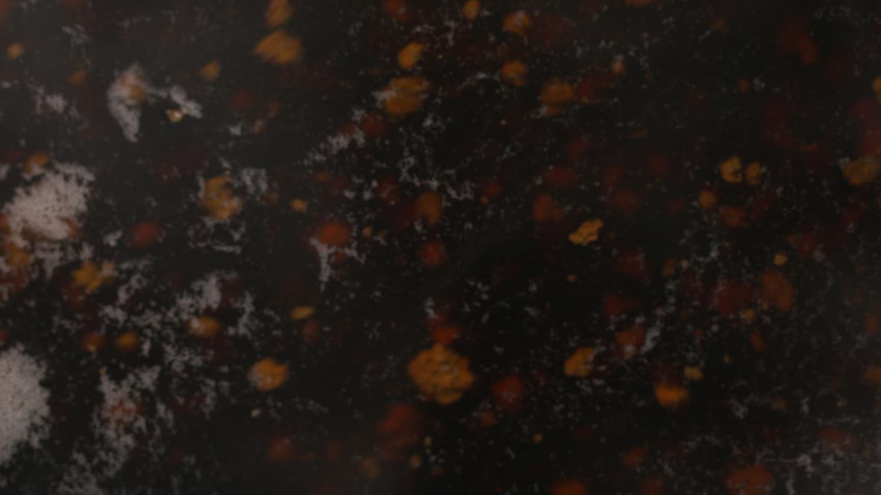 A macro view of tea particles floating in the kettle while preparing it