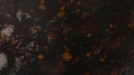 a macro view of tea particles floating in the kettle while preparing it