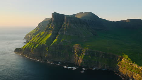 Dramatic Green Cliffs Meeting the Ocean at Golden Hour