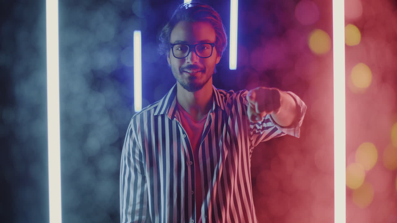 Stylish Man in a Striped Shirt with Neon Lights