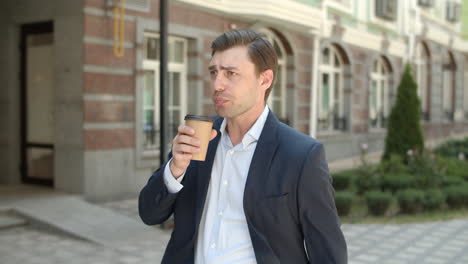 man drinking coffee before work. businessman looking at smart watch