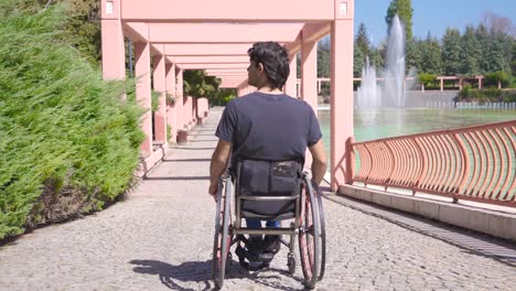 wheelchair wheels, difficulty in wheelchair on the street, disabled man.