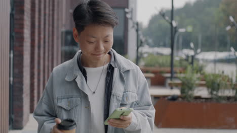 Young Woman Walking and Using Smartphone