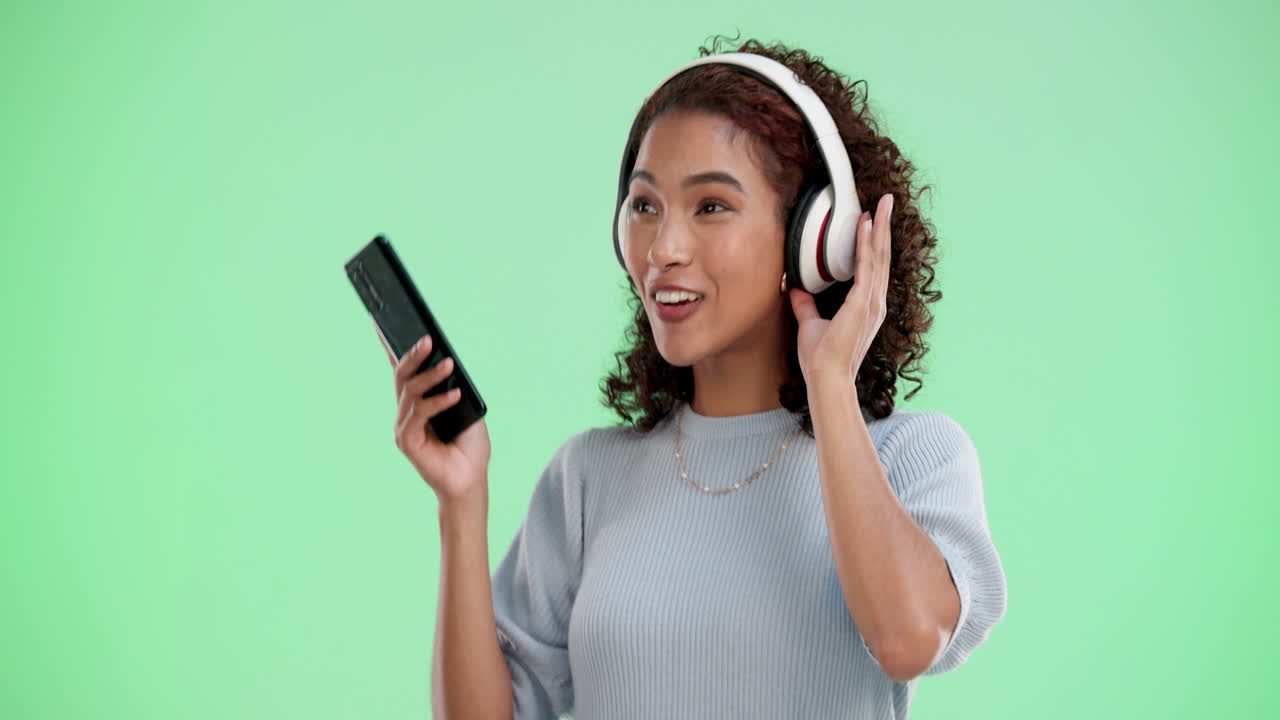 Woman enjoying music with headphones and phone